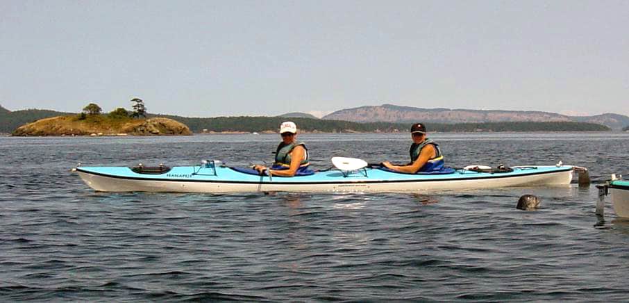two people in a double kayak out on the water