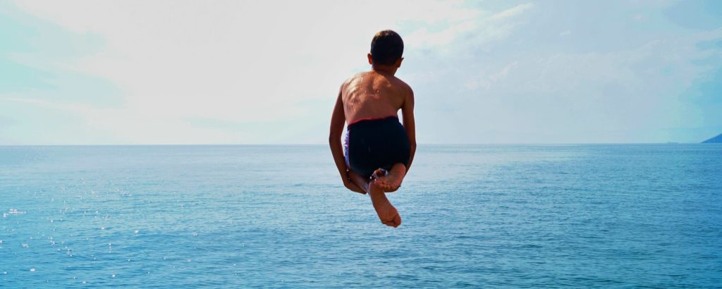 child diving into the water