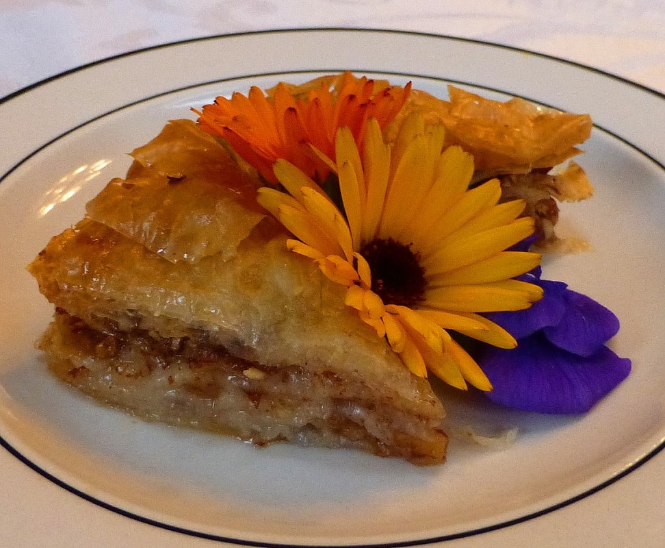 Baklava on a plate garnished iwth flowers