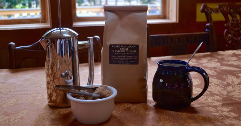 french press and coffee mug on a dining table, enjoy Friday Harbor Coffee Shops