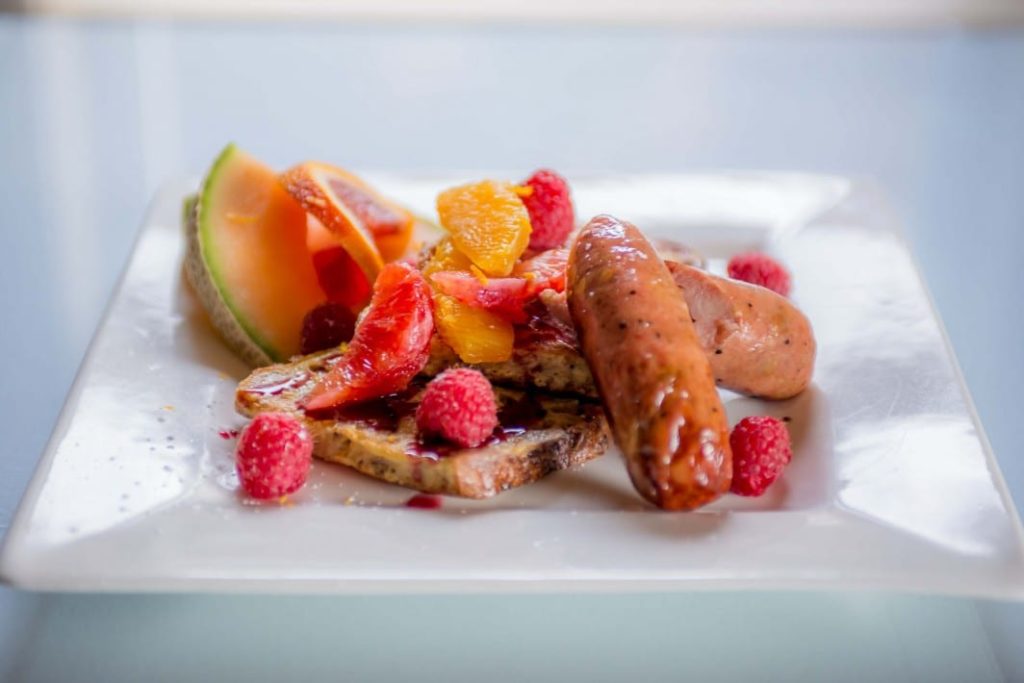 Plate of French Toast with Raspberry Sauce and sausage links