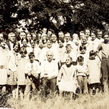 historic image of a large group of people standing in a field