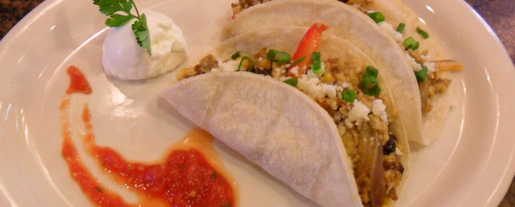 two Southwest Soft Egg Tacos with salsa and sour cream