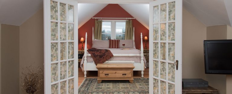 French doors open to a bedroom