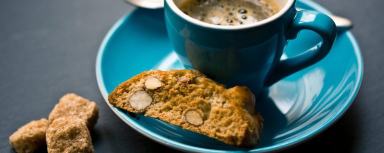 coffee and biscotti on a blue plate
