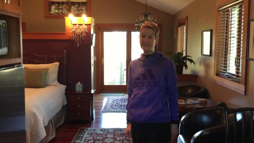 woman wearing purple sweatshirt standing in a suite