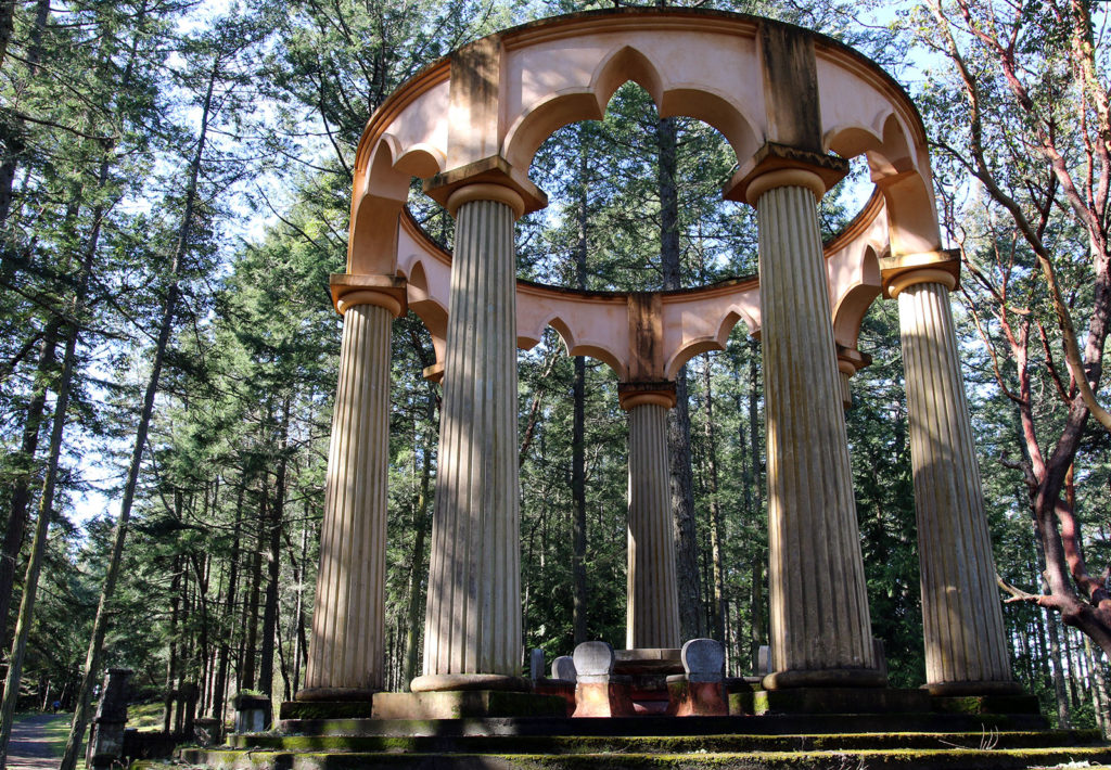 Monument with large columns in a forested area