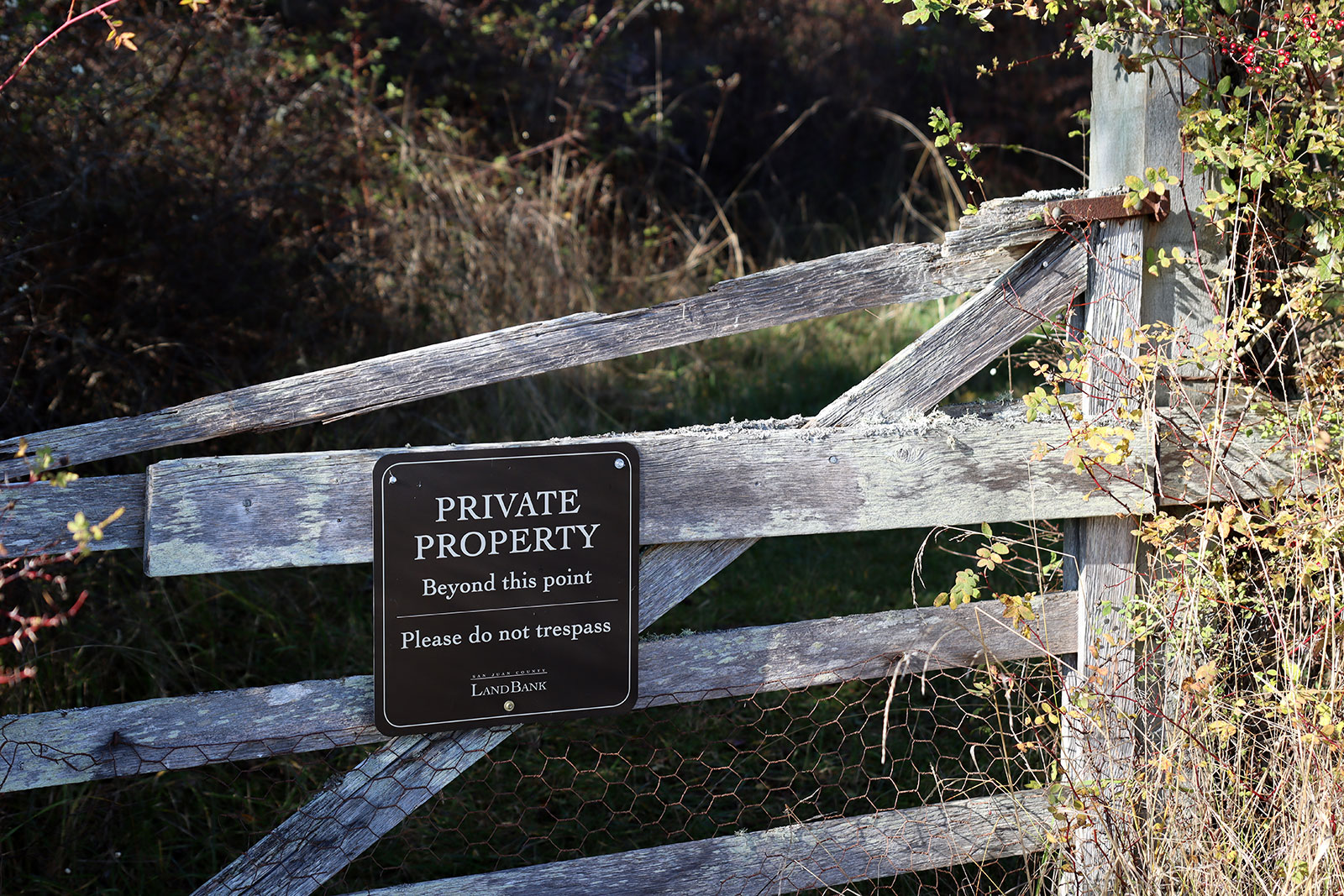 Private property sign on a wooden fence gate