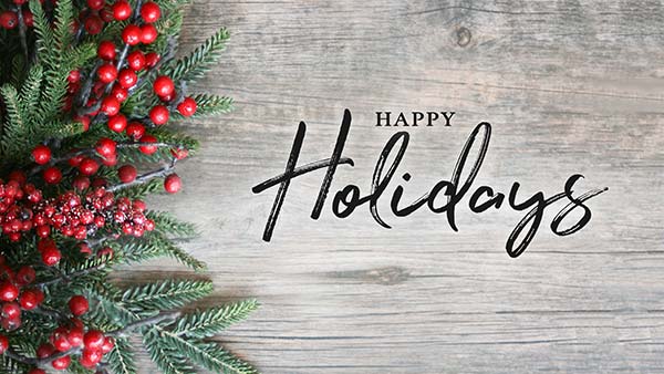 Greenery, red berries, and a Happy Holidays message