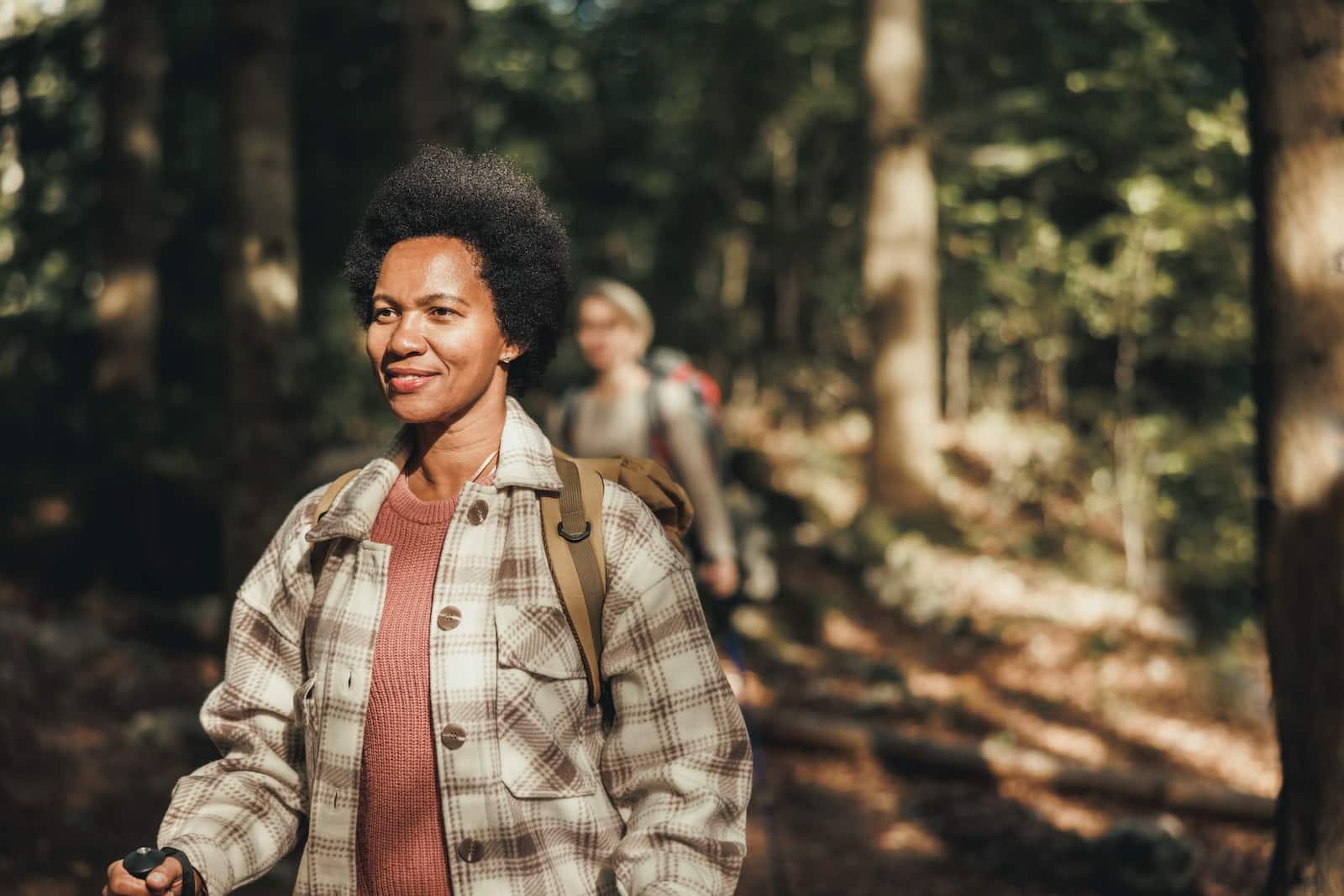 Mature black woman hiking on mountain in a beautiful sunny autumn day on one of the best San Juan Island Hikes 