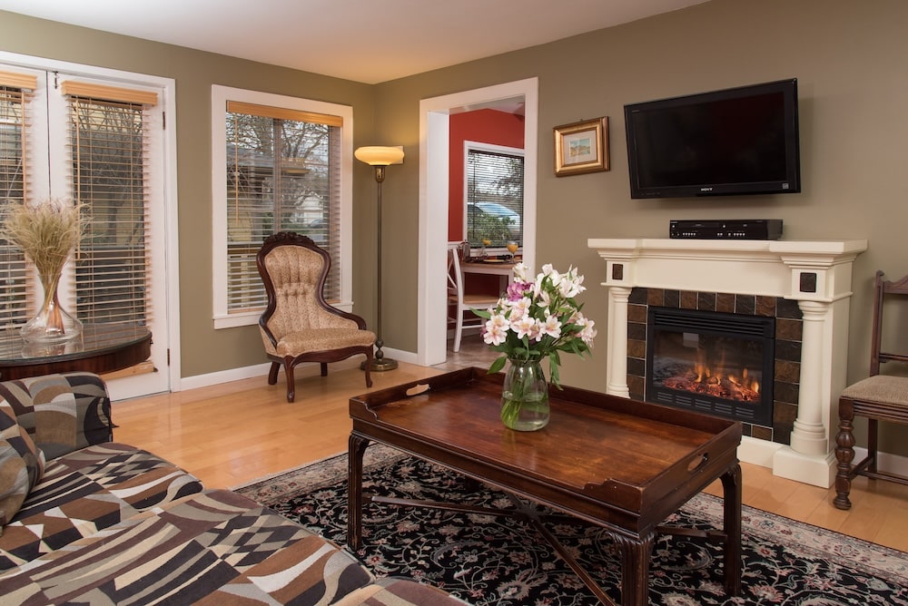 A cozy guest room with a fireplace at our Friday Harbor Lodging