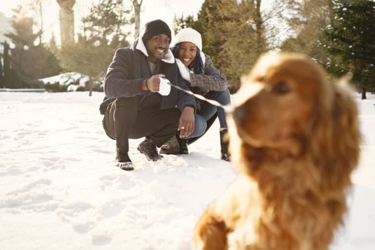 Romantic couple with a dog outside as they enjoy secluded romantic getaways in Washington State