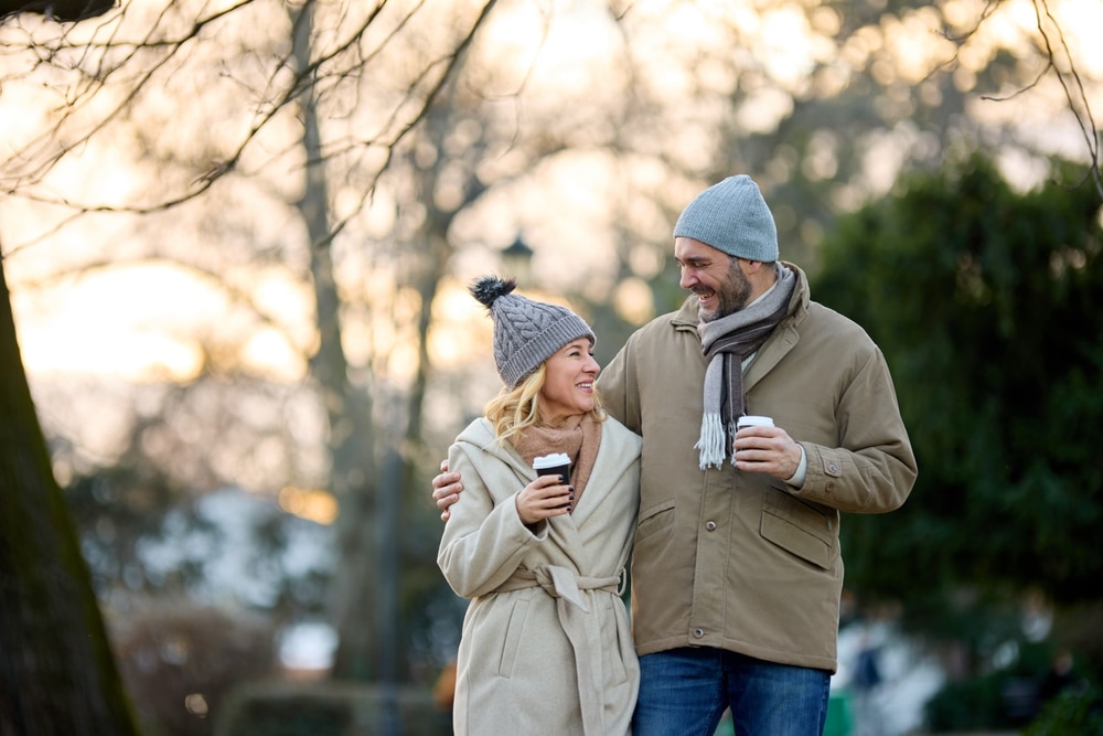 A couple walking with coffee and enjoying the best things to do on San Juan Island in winter