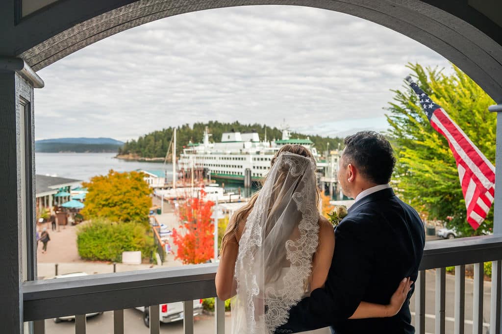 bridal couple looking at the ferry landing from an upper balcony