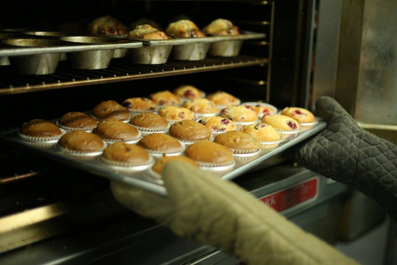 muffins being pulled from the oven