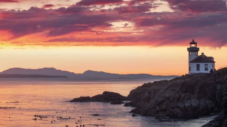 Visit the Lime Kiln Lighthouse at sunset.